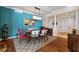 Stylish dining room with modern light fixture, sleek furniture, and elegant decor against a blue accent wall at 2515 S Atlantic Ave # 509, Daytona Beach, FL 32118