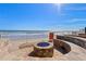Community fire pit with stone seating area overlooking the beach and ocean at 2515 S Atlantic Ave # 509, Daytona Beach, FL 32118