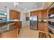 Bright kitchen featuring stainless steel appliances, granite counters, and tiled floors, offering space and style at 2515 S Atlantic Ave # 509, Daytona Beach, FL 32118