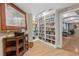 Cozy library with extensive bookshelves and a comfortable seating area through the doorway at 2515 S Atlantic Ave # 509, Daytona Beach, FL 32118