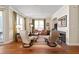 Cozy living room with a fireplace, comfortable seating, and large windows providing ample natural light and views at 2515 S Atlantic Ave # 509, Daytona Beach, FL 32118