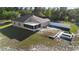 Aerial view showing backyard with a screened patio, garden plots, and a white picket fence at 2530 Leonard Dr, Deltona, FL 32725