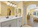 Bright bathroom featuring double sinks and quartz counters with an attached bedroom and closet at 2530 Leonard Dr, Deltona, FL 32725