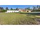 Well-maintained home featuring a large front yard, attractive landscaping, and a covered parking area at 2530 Leonard Dr, Deltona, FL 32725