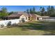 Exterior angle showcasing the fenced yard, well-maintained lawn, and the side of the house and carport at 2530 Leonard Dr, Deltona, FL 32725