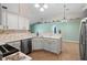 Kitchen with white cabinets, stainless appliances, tile flooring, and an inviting breakfast bar at 2530 Leonard Dr, Deltona, FL 32725