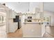 Bright kitchen features white cabinets, stainless steel appliances, and a breakfast bar at 2530 Leonard Dr, Deltona, FL 32725