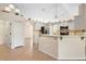 Spacious kitchen featuring white cabinets, stainless steel appliances, and breakfast bar seating at 2530 Leonard Dr, Deltona, FL 32725