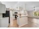 Bright kitchen featuring white cabinets, stainless appliances, tile floors, and an eat-in breakfast bar at 2530 Leonard Dr, Deltona, FL 32725