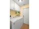 Well-lit laundry room boasts ample cabinet space above the washer and dryer, and a convenient utility sink at 2530 Leonard Dr, Deltona, FL 32725