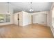 Spacious open-plan living room with wood floors, neutral walls, tall ceilings and an arched doorway at 2530 Leonard Dr, Deltona, FL 32725
