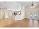 Open-concept living room with tile and wood floors, connecting to the kitchen and patio at 2530 Leonard Dr, Deltona, FL 32725