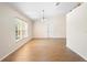 Bright, open-concept living room features wood floors, neutral paint, tall ceilings and natural light at 2530 Leonard Dr, Deltona, FL 32725