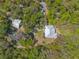 An aerial view displays the property, including a large pond and surrounding lush landscape at 2646 Turnbull Bay Rd, New Smyrna Beach, FL 32168
