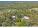 Aerial showcasing the property's pond, treed acreage, and proximity to equestrian facilities at 2646 Turnbull Bay Rd, New Smyrna Beach, FL 32168