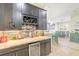 Elegant bar area with dark cabinets, wine rack, and marble countertops at 2646 Turnbull Bay Rd, New Smyrna Beach, FL 32168