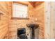 Unique bathroom with a pedestal sink and wood paneled walls at 2646 Turnbull Bay Rd, New Smyrna Beach, FL 32168