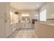 Modern bathroom with patterned tile, gold fixtures, and a glass-enclosed shower, providing a spa-like experience at 2646 Turnbull Bay Rd, New Smyrna Beach, FL 32168