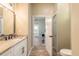 Elegant bathroom with a granite vanity, modern fixtures, and wood flooring, offering a luxurious feel at 2646 Turnbull Bay Rd, New Smyrna Beach, FL 32168