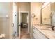Modern bathroom with granite countertops, dual vanity, and a glass-enclosed shower, creating a spa-like retreat at 2646 Turnbull Bay Rd, New Smyrna Beach, FL 32168