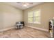 Bright bedroom with wood-look tile floors and window with plantation shutters at 2646 Turnbull Bay Rd, New Smyrna Beach, FL 32168