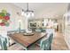 Inviting dining area with rustic wood table, coastal decor, and an open floor plan at 2646 Turnbull Bay Rd, New Smyrna Beach, FL 32168