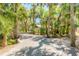 Long driveway winding through lush trees, creating a secluded and serene entrance to the property at 2646 Turnbull Bay Rd, New Smyrna Beach, FL 32168