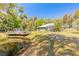 Beautiful property featuring lush landscaping, pond with deck, and screened-in porch offering serene outdoor living at 2646 Turnbull Bay Rd, New Smyrna Beach, FL 32168