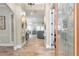 Inviting foyer featuring wood-look tile, archways, and a glimpse into the open-concept living spaces at 2646 Turnbull Bay Rd, New Smyrna Beach, FL 32168