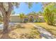 Inviting single-story home with a well-kept lawn, mature trees, and a welcoming entryway at 2646 Turnbull Bay Rd, New Smyrna Beach, FL 32168