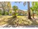 Beautifully landscaped single-story home with mature trees and a well-maintained lawn at 2646 Turnbull Bay Rd, New Smyrna Beach, FL 32168