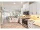 Bright kitchen with stainless appliances, granite counters, and ample cabinet space at 2646 Turnbull Bay Rd, New Smyrna Beach, FL 32168