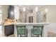 Open concept kitchen with marble counter, breakfast bar, and modern appliances at 2646 Turnbull Bay Rd, New Smyrna Beach, FL 32168