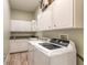 Convenient laundry room with modern washer, dryer, and ample storage at 2646 Turnbull Bay Rd, New Smyrna Beach, FL 32168