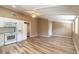 Open layout featuring a bright kitchen with white appliances and an adjacent living space with wood floors at 2646 Turnbull Bay Rd, New Smyrna Beach, FL 32168