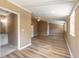 Spacious open-plan living room featuring wood-look floors and lots of natural light at 2646 Turnbull Bay Rd, New Smyrna Beach, FL 32168