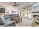 Inviting living room featuring a large sectional sofa, fireplace, and sliding glass doors to the patio at 2646 Turnbull Bay Rd, New Smyrna Beach, FL 32168