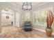 Living room featuring a tray ceiling, a ceiling fan, and large windows with plantation shutters at 2646 Turnbull Bay Rd, New Smyrna Beach, FL 32168