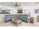 Spacious living room with modern decor, gray sectional, and wood-look flooring at 2646 Turnbull Bay Rd, New Smyrna Beach, FL 32168