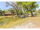 Scenic view of a pond with a fountain, surrounded by mature trees and landscaping at 2646 Turnbull Bay Rd, New Smyrna Beach, FL 32168