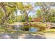 Idyllic backyard pond with a fountain, surrounded by lush greenery and mature trees, creating a serene atmosphere at 2646 Turnbull Bay Rd, New Smyrna Beach, FL 32168