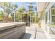 Tranquil screened porch featuring a hot tub and views of the outdoor landscape at 2646 Turnbull Bay Rd, New Smyrna Beach, FL 32168