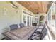 Spacious screened porch with wood ceiling, adorned with coastal decor, perfect for outdoor entertaining at 2646 Turnbull Bay Rd, New Smyrna Beach, FL 32168