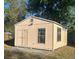 Exterior view of detached shed with double doors and windows at 2684 Candler Dr, Deltona, FL 32725