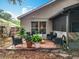 Backyard patio with seating amidst lush potted plants, great for relaxation and enjoying the outdoor ambiance at 30029 Pga Dr, Sorrento, FL 32776