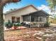 Outdoor space with screened patio and seating area, complemented by lush greenery and mature trees at 30029 Pga Dr, Sorrento, FL 32776