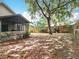 Expansive backyard featuring a screened patio and mature trees, creating a private outdoor space at 30029 Pga Dr, Sorrento, FL 32776