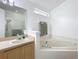 This bright bathroom features a large bathtub and glass-doored shower at 30029 Pga Dr, Sorrento, FL 32776