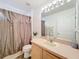 Bathroom featuring laminate countertop, decorative mirror, and walk in shower at 30029 Pga Dr, Sorrento, FL 32776