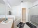 This bathroom is bright and clean with a large bathtub and glass-doored shower at 30029 Pga Dr, Sorrento, FL 32776
